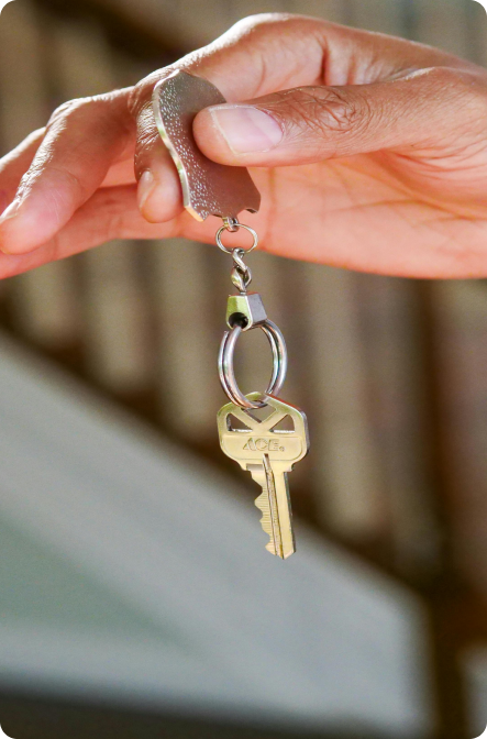 Person Holding a Keychain with Key